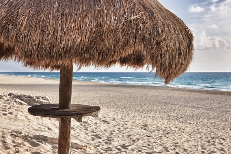 Palapa thatch sun umbrella on the beach at Cancun